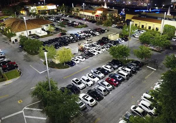 An aerial view of the outdoor LED lighting at The Palms Town Country building and parking lot at night